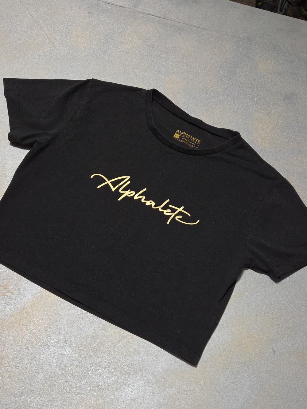 Alphalete Black Cropped Tee with Gold Script Logo